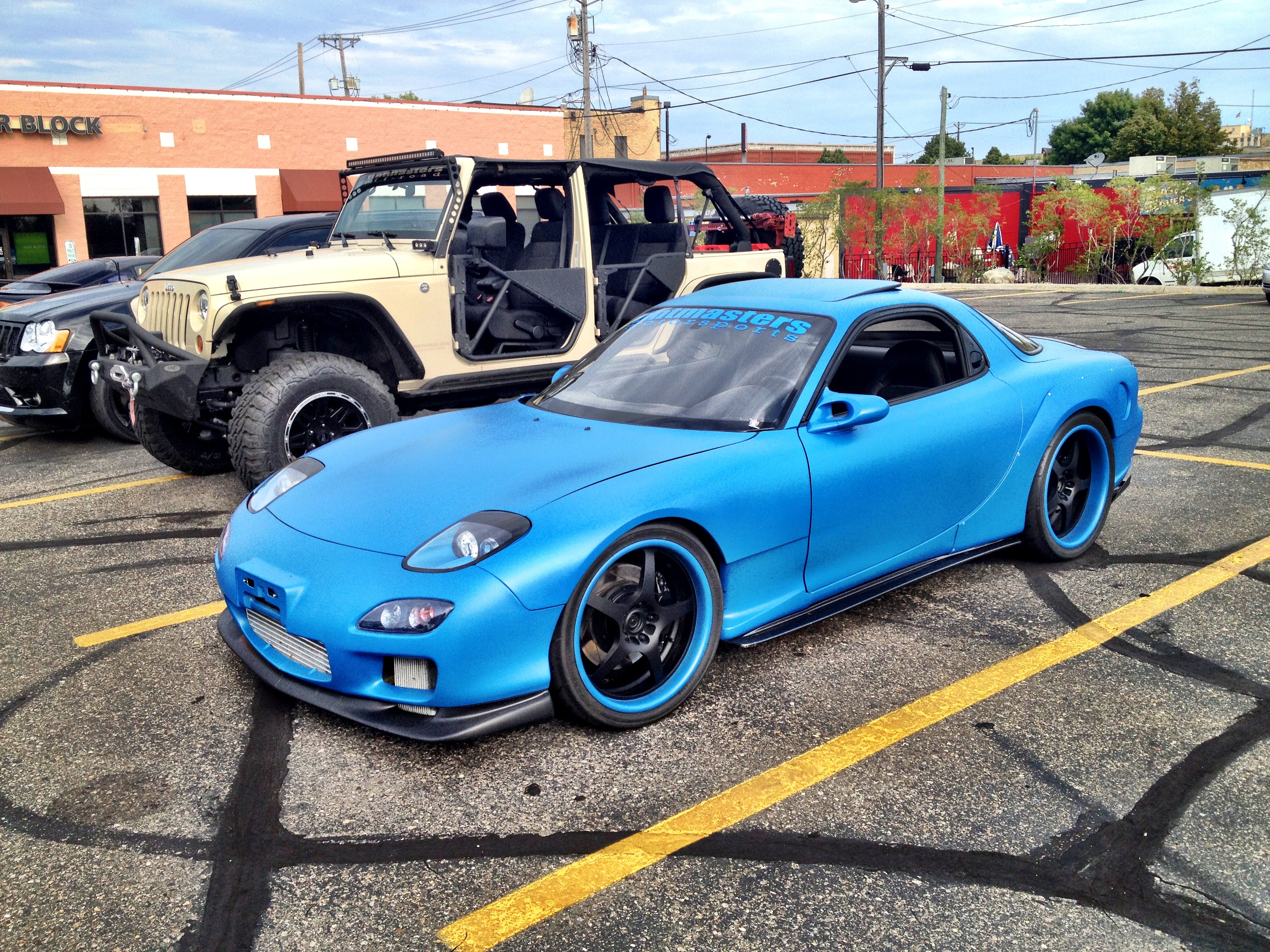 This early 90’s Mazda RX-7 had a custom widebody painted flat blue with mat...